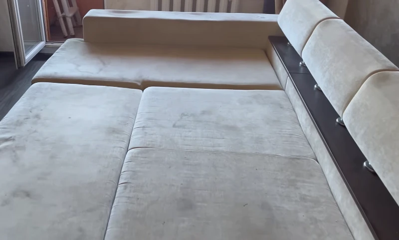 Sectional sofa cushion with heavily embedded dirt and stains before professional upholstery cleaning — Medford OR